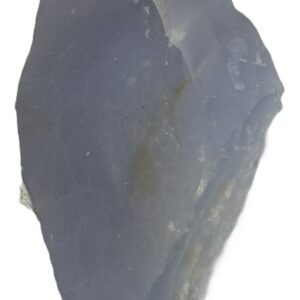A raw and polished display piece of natural blue lace agate showing delicate periwinkle and white chalcedony bands surrounding an interior druzy quartz vug set against its natural host matrix sians emporium Rough natural blue lace agate freeform specimen featuring soft blue banding and an exposed sparkling druzy quartz crystal in matrix rock