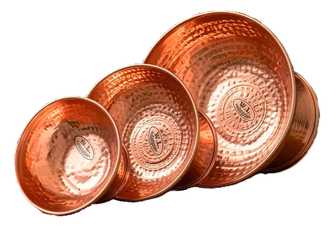Handcrafted hammered copper singing bowl set meditation sound healing sians emporium Three handcrafted hammered copper singing bowls in different sizes displayed on a wooden table for meditation sound healing mindfulness and spiritual practice