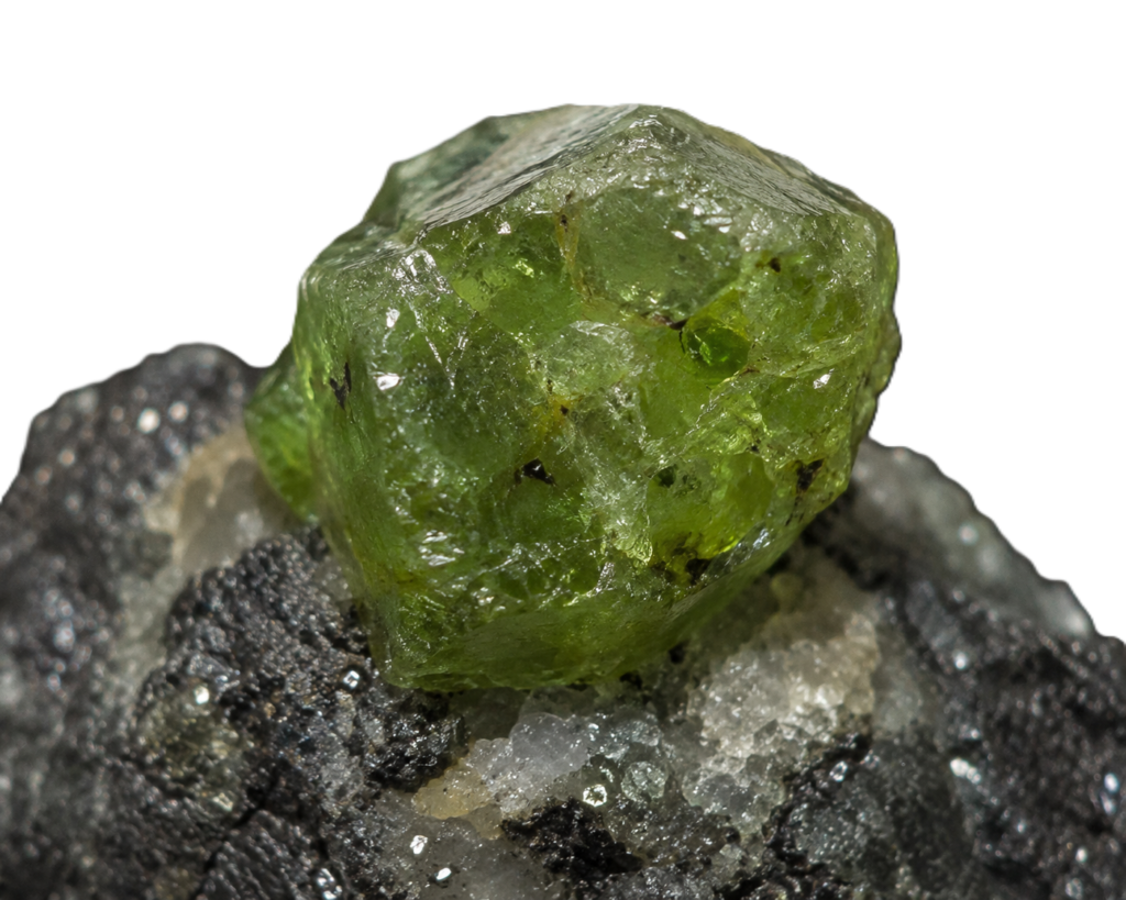 Raw demantoid garnet crystal specimen sians emporium Raw demantoid garnet crystal on its natural rock matrix showing transparent olive green andradite garnet