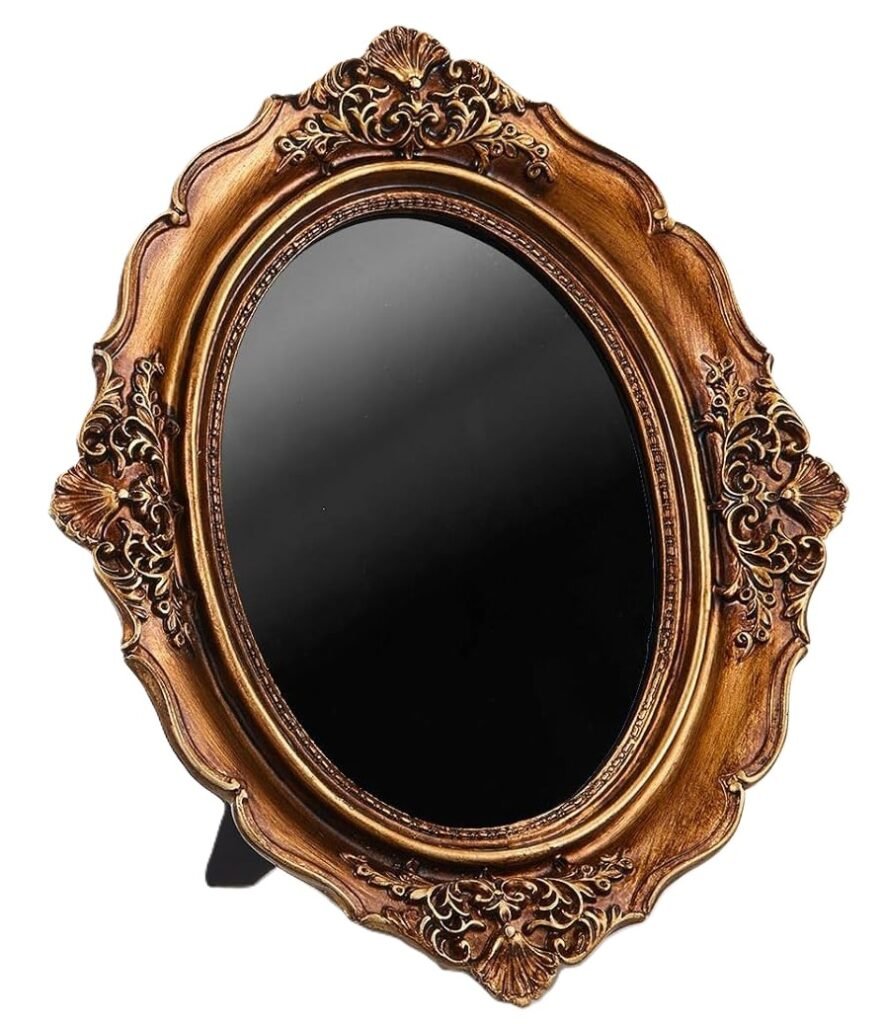 Antique black scrying mirror in ornate gold frame sians emporium An ornate antique style black scrying mirror with an oval obsidian like reflective surface set within an intricately carved gold frame used for divination meditation and spiritual practice