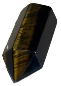 Natural blue and gold tigers eye crystal point tower1 sians emporium Polished dual tone blue and gold tiger's eye crystal point standing upright, showing golden chatoyant bands and dark blue-black tones on a white background.